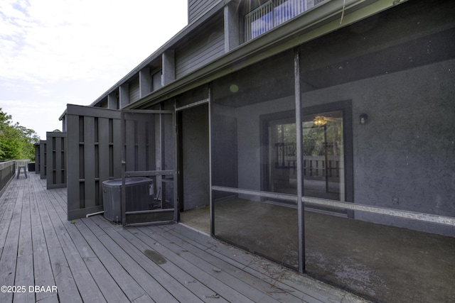 wooden deck featuring cooling unit