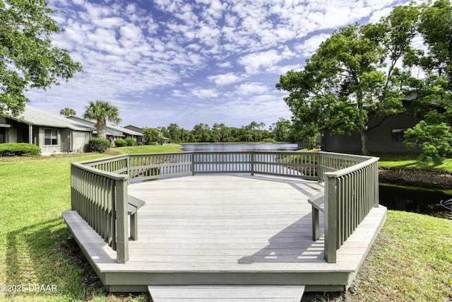 wooden terrace with a lawn and a water view