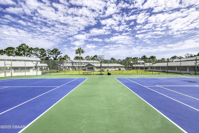 view of tennis court with fence and community basketball court