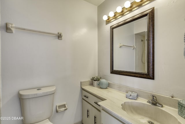 bathroom featuring vanity, toilet, and a shower