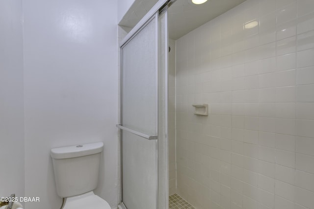 bathroom with toilet and a stall shower
