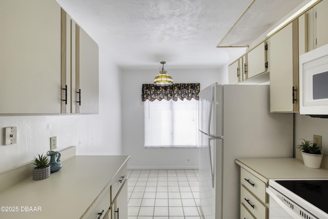 kitchen with light countertops, white appliances, light tile patterned flooring, decorative light fixtures, and baseboards