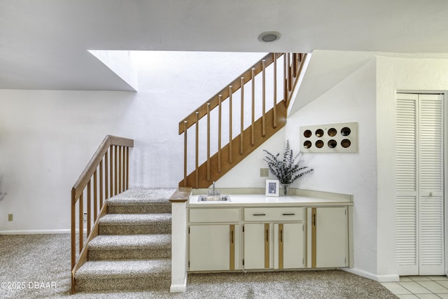 stairs with baseboards and carpet flooring