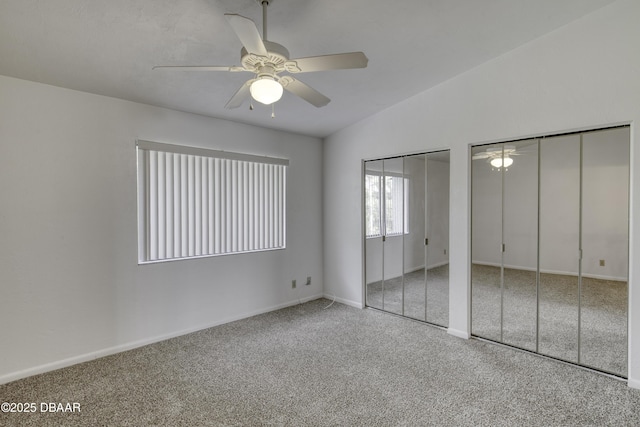 unfurnished bedroom with multiple closets, carpet, baseboards, and ceiling fan