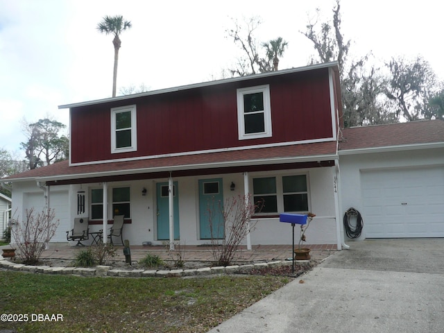 view of front of home with a porch and a garage