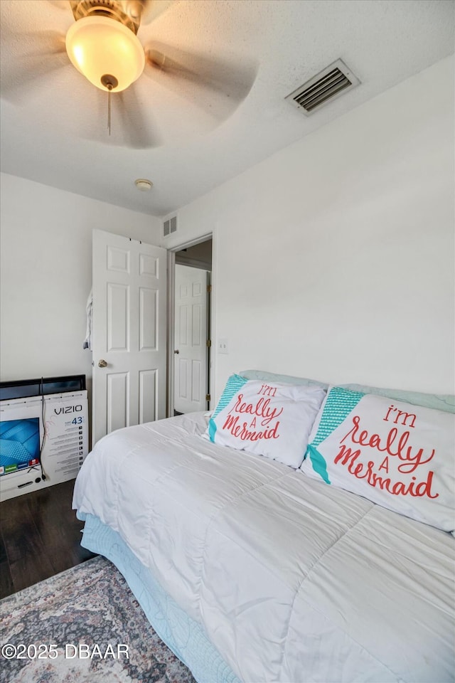 16 Powder Hill Ln, Palm Coast, FL 32164 - bedroom with wood finished floors, visible vents, and a ceiling fan