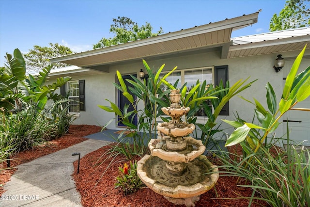 16 Powder Hill Ln, Palm Coast, FL 32164 - view of property exterior with metal roof and stucco siding