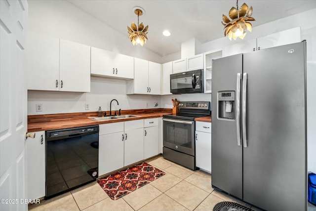 16 Powder Hill Ln, Palm Coast, FL 32164 - kitchen with white cabinets, light tile patterned floors, a sink, black appliances, and butcher block countertops