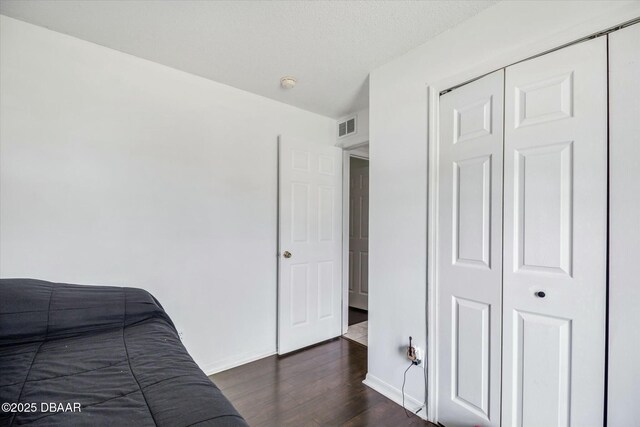 16 Powder Hill Ln, Palm Coast, FL 32164 - bedroom with dark wood-type flooring, a closet, visible vents, and baseboards