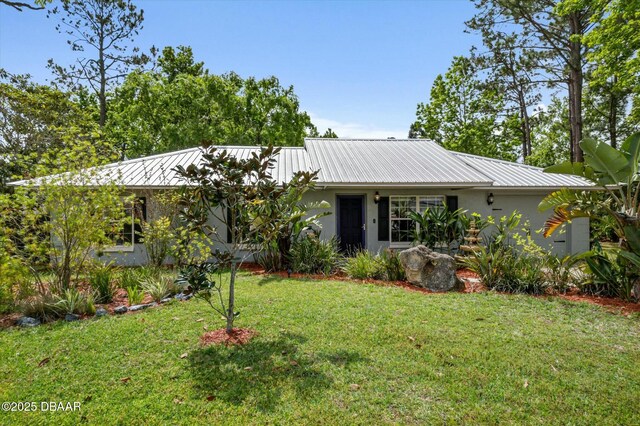 16 Powder Hill Ln, Palm Coast, FL 32164 - ranch-style house with stucco siding, a front lawn, and metal roof