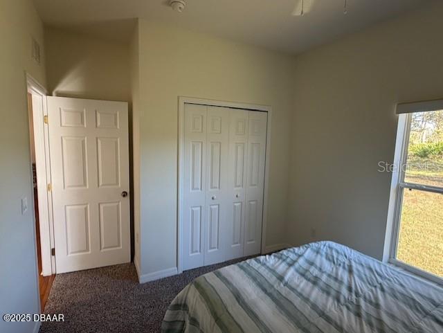 bedroom featuring a closet and dark carpet