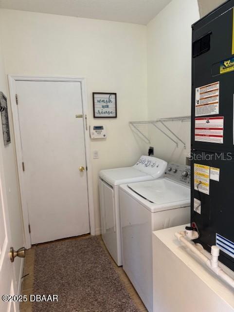 washroom with washer and dryer and heating unit