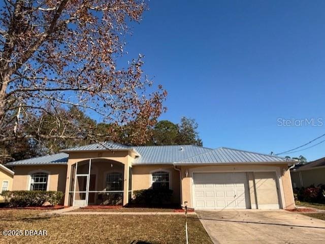 single story home with a sunroom and a garage