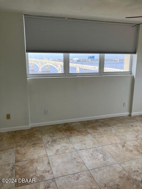 tiled spare room with plenty of natural light