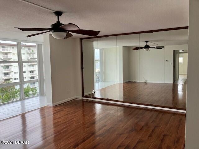 empty room with hardwood / wood-style flooring and a textured ceiling