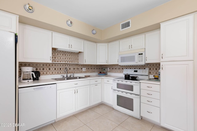 kitchen featuring tasteful backsplash, sink, white cabinets, light tile patterned floors, and white appliances