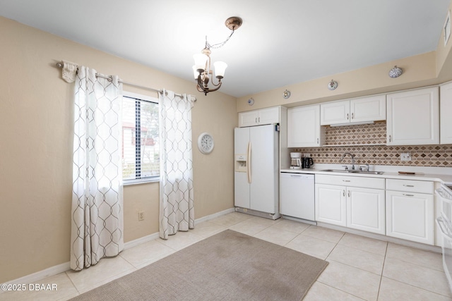 kitchen featuring sink, light tile patterned floors, pendant lighting, white appliances, and white cabinets