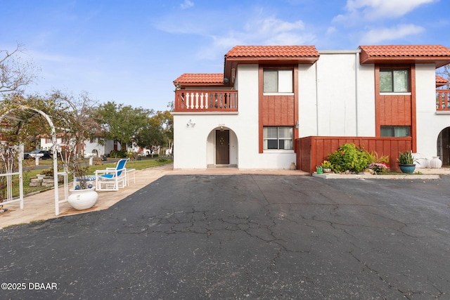 view of front of home with a patio area and a balcony