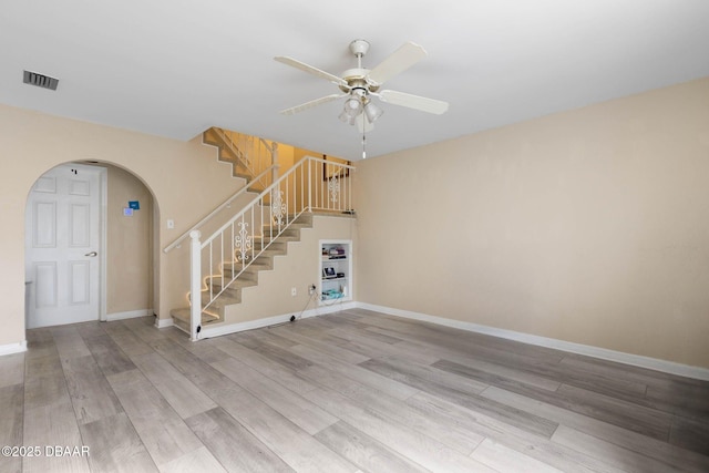 interior space featuring wood-type flooring and ceiling fan