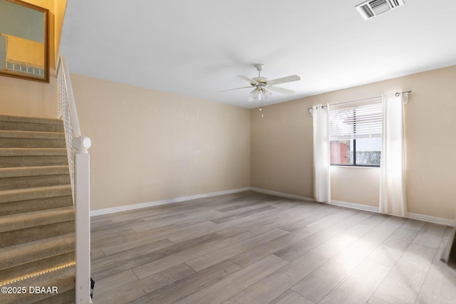 spare room with ceiling fan and light hardwood / wood-style floors