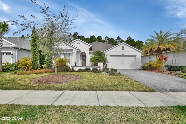 view of front of property featuring a garage, decorative driveway, a front yard, and stucco siding