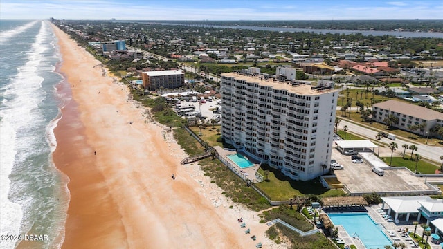 drone / aerial view with a water view and a view of the beach