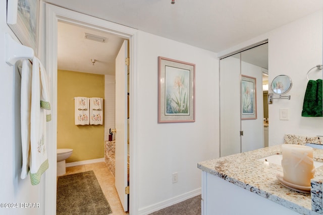 bathroom with toilet and vanity