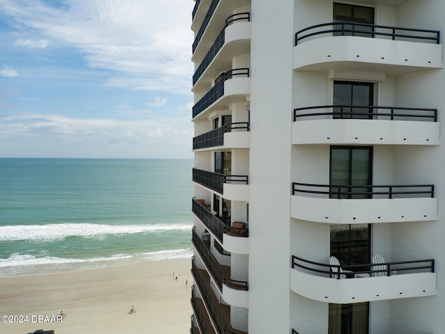 exterior space with a water view and a view of the beach