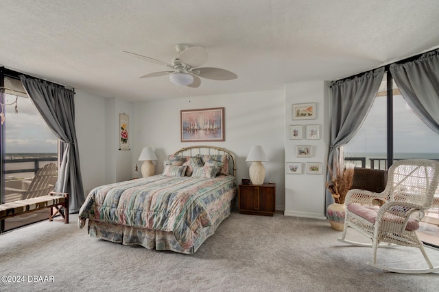 bedroom with carpet, a textured ceiling, and ceiling fan