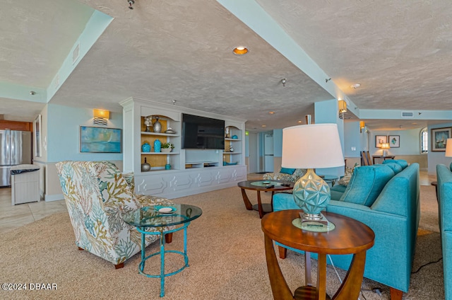 carpeted living room featuring built in shelves and a textured ceiling