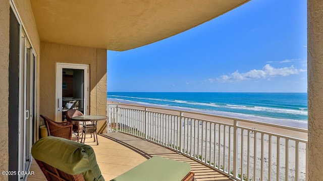 balcony featuring view of water and beach