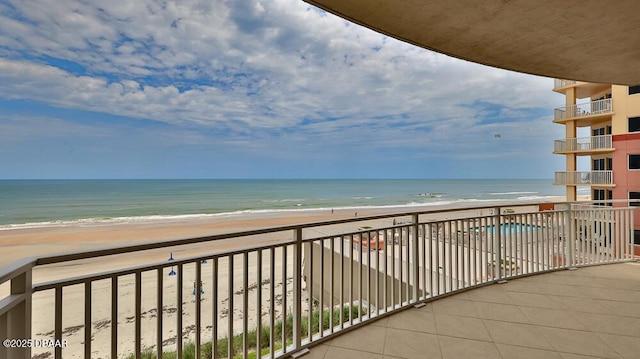 balcony with view of water and beach