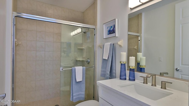 bathroom with a shower stall, vanity, and toilet