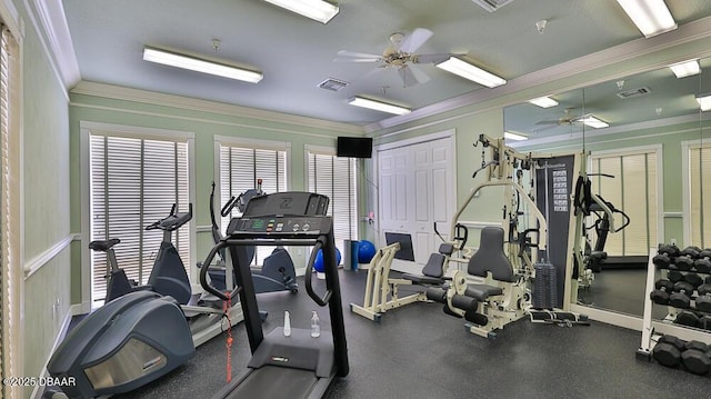 exercise room featuring ceiling fan and ornamental molding