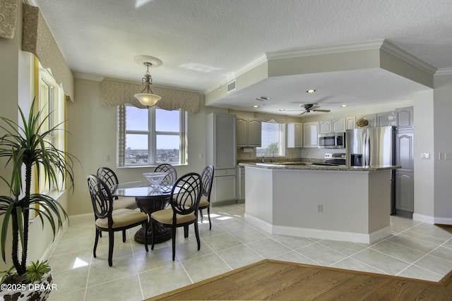 2300 N Atlantic Ave Unit 303, Daytona Beach, FL 32118 - kitchen featuring gray cabinets, light tile patterned floors, crown molding, visible vents, and stainless steel appliances