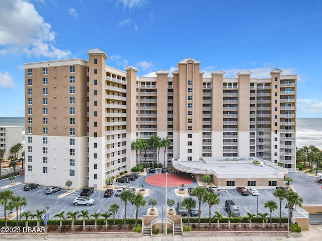 2403 S Atlantic Ave Unit 409, Daytona Beach Shores, FL 32118 - view of apartment building / complex with a water view and uncovered parking