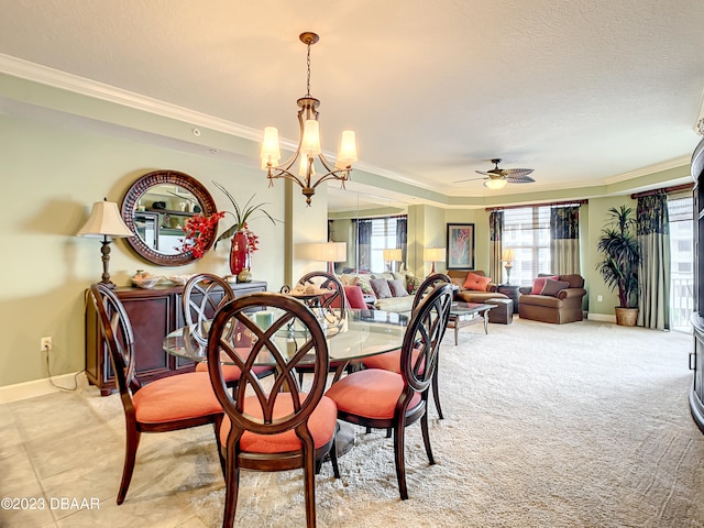 dining area with a textured ceiling, ornamental molding, and ceiling fan with notable chandelier