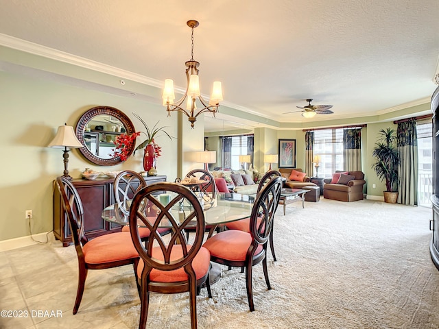 2403 S Atlantic Ave Unit 409, Daytona Beach Shores, FL 32118 - dining room featuring ornamental molding, a chandelier, a ceiling fan, baseboards, and a textured ceiling