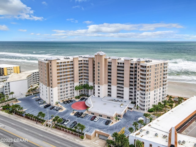 birds eye view of property featuring a water view and a view of the beach