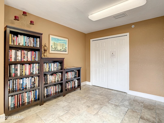 2403 S Atlantic Ave Unit 409, Daytona Beach Shores, FL 32118 - sitting room with baseboards and stone finish floors