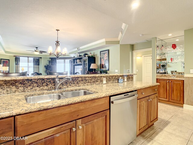 kitchen featuring light stone countertops, pendant lighting, sink, dishwasher, and ceiling fan with notable chandelier