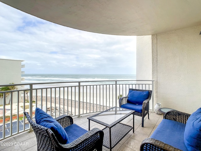 balcony with a beach view and a water view