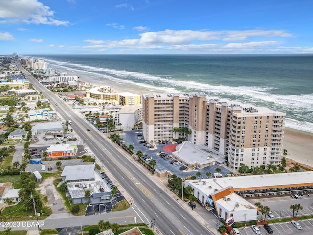 bird's eye view featuring a view of the beach and a water view