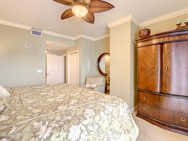 bedroom featuring ceiling fan, carpet flooring, a closet, and ornamental molding