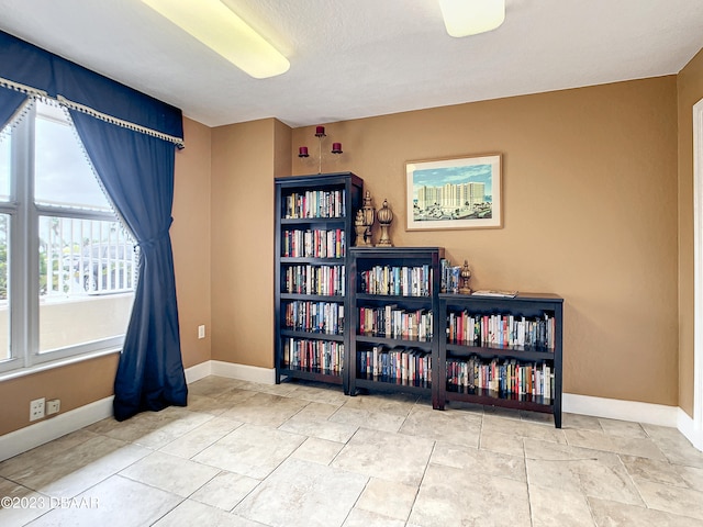 interior space with a textured ceiling and light tile patterned floors