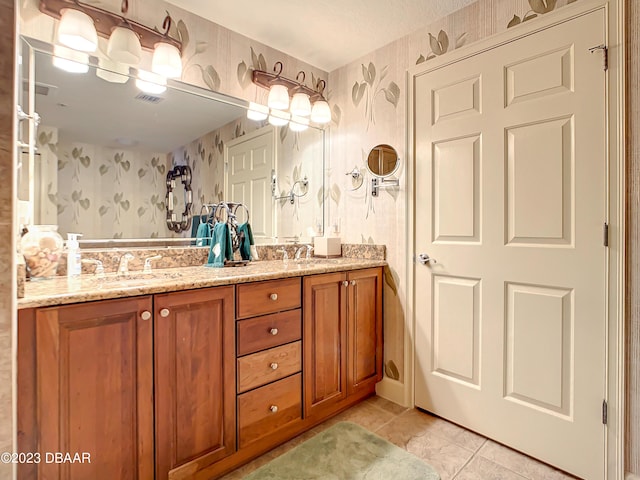2403 S Atlantic Ave Unit 409, Daytona Beach Shores, FL 32118 - bathroom featuring wallpapered walls, tile patterned floors, and double vanity
