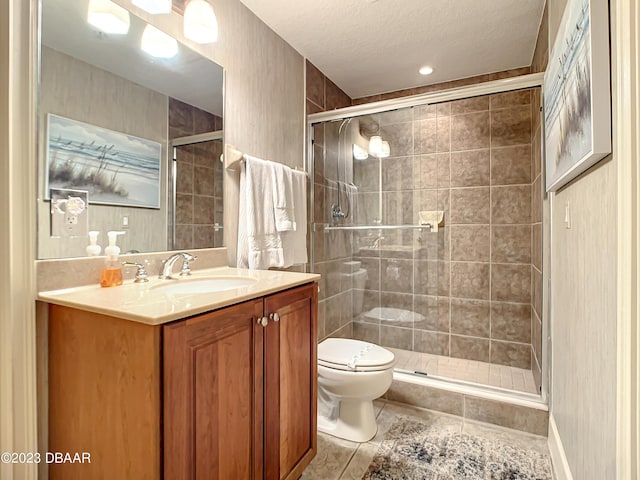 2403 S Atlantic Ave Unit 409, Daytona Beach Shores, FL 32118 - bathroom with toilet, tile patterned floors, a stall shower, vanity, and a textured ceiling