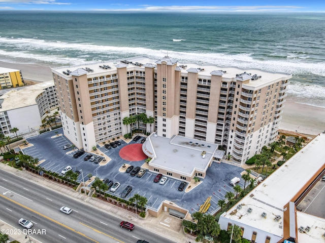 drone / aerial view with a beach view and a water view