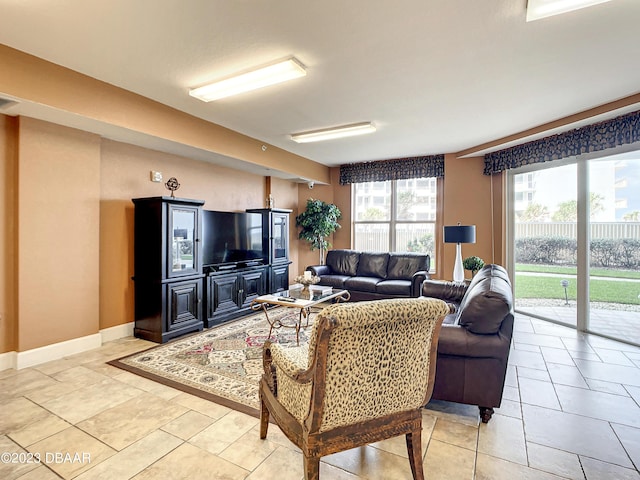 2403 S Atlantic Ave Unit 409, Daytona Beach Shores, FL 32118 - living room featuring baseboards and light tile patterned flooring