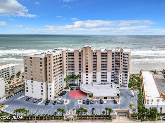 bird's eye view featuring a view of the beach and a water view